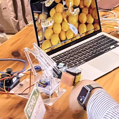 A clear acrylic robotic arm demo at the class mini expo
